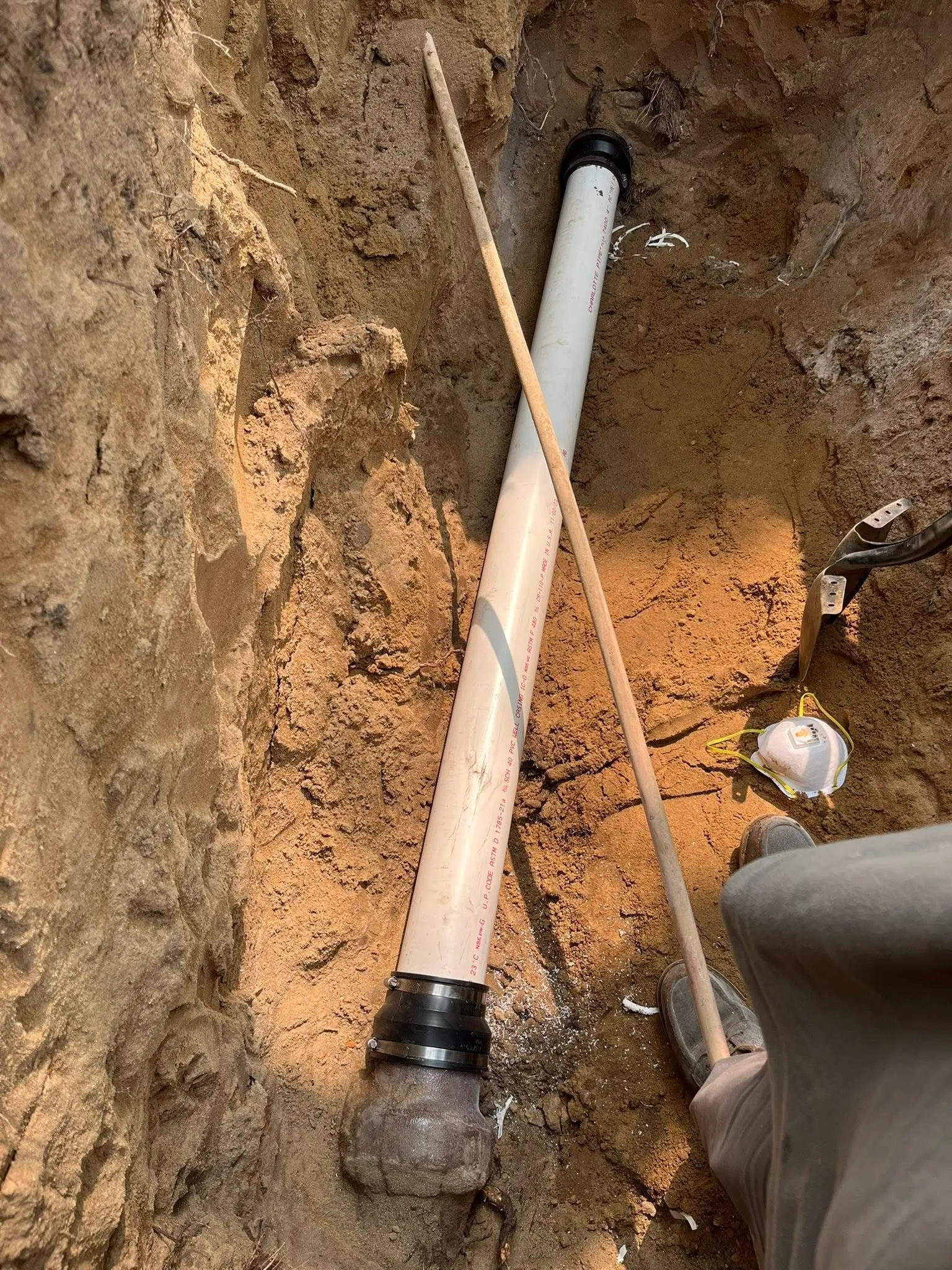 Drain pipe and fittings installed in a hand-dug trench